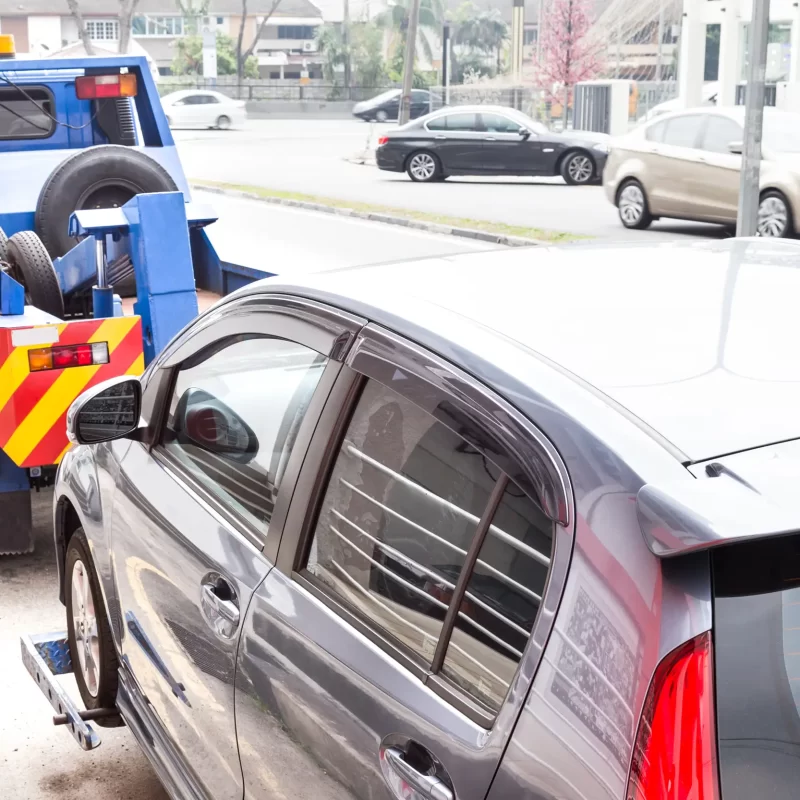 tow-truck-towing-a-broken-down-car-on-the-street-2025-03-05-01-31-09-utc